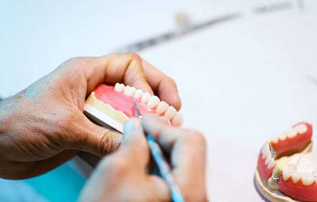 a technician working on creating dentures