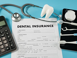Patient in Selbyville reviewing dental insurance paperwork for root canal treatment 