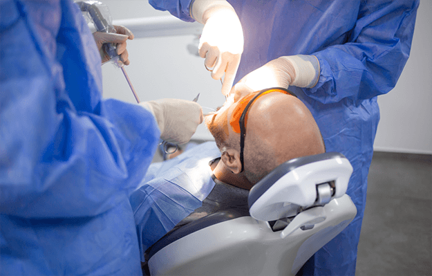 Dentist in Shelbyville helping patient recover a dental implant